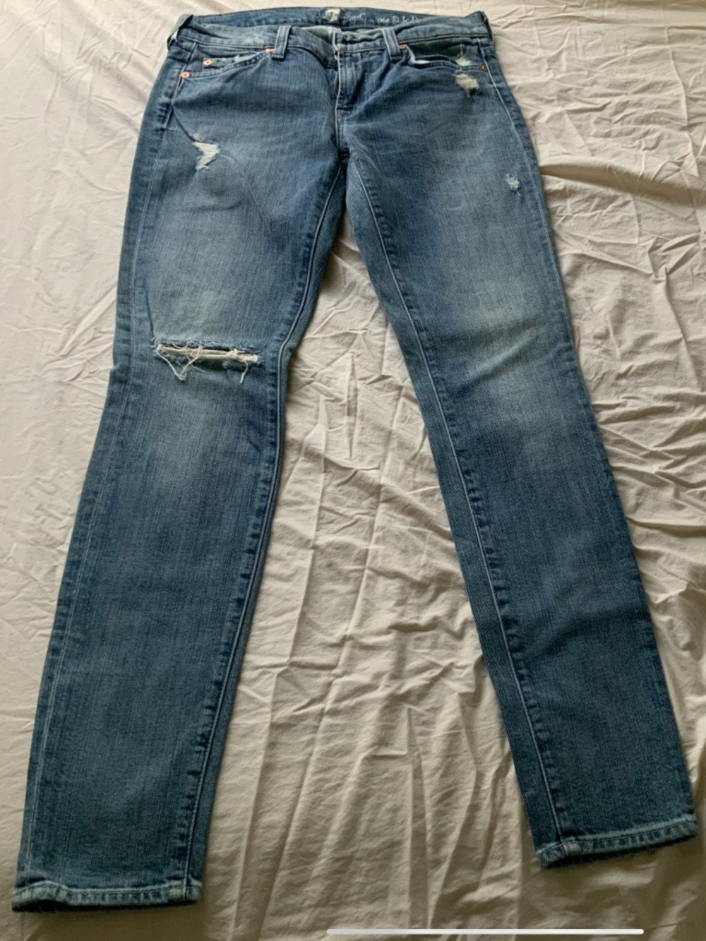 This is a pair of 7 Seven For all Mankind Skinny Jeans Distressed Size 27
